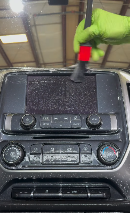 Detailing a dusty dashboard and center console by hand