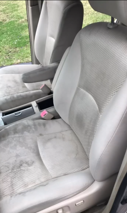 Dirty front car seats before mobile detailing